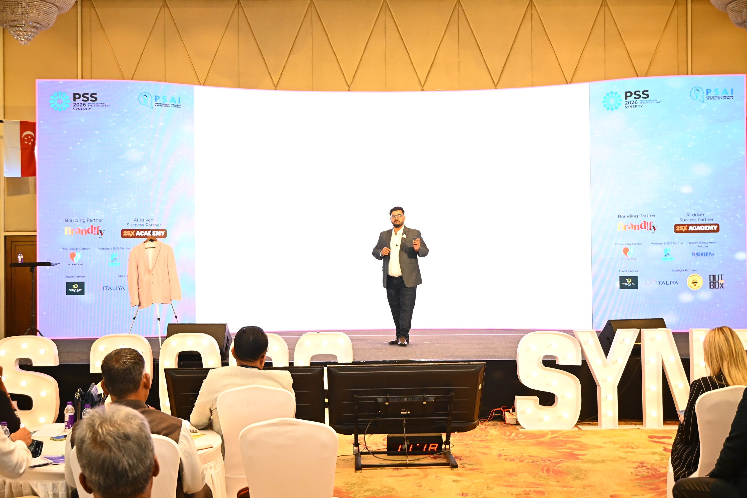 Mithyll Dave delivering a keynote on stage at the PSS2026 Summit in Chennai, wide shot